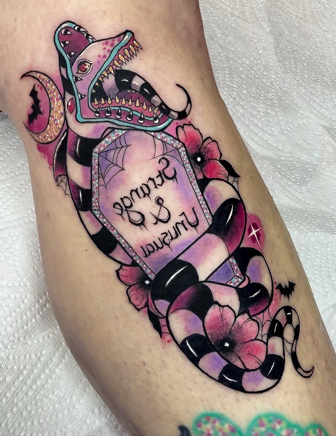 Unique Beetlejuice-themed snake tattoo design