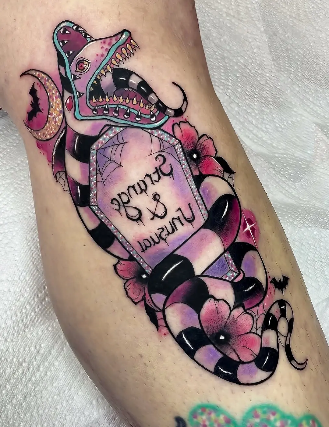 Unique Beetlejuice-themed snake tattoo design