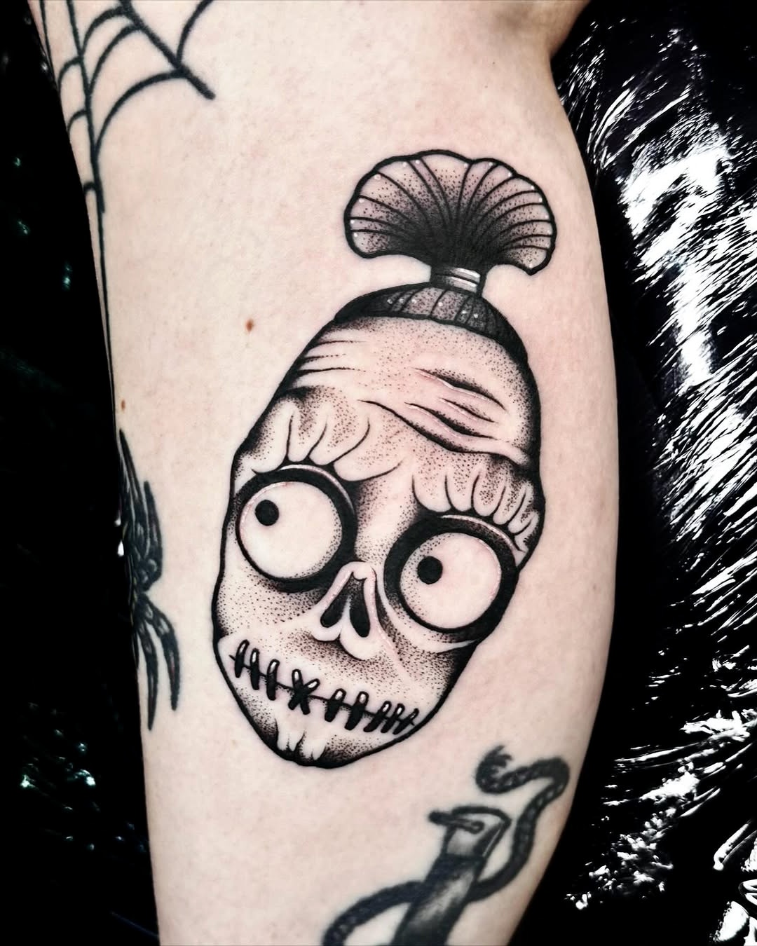 Creative Beetlejuice-inspired skull tattoo design