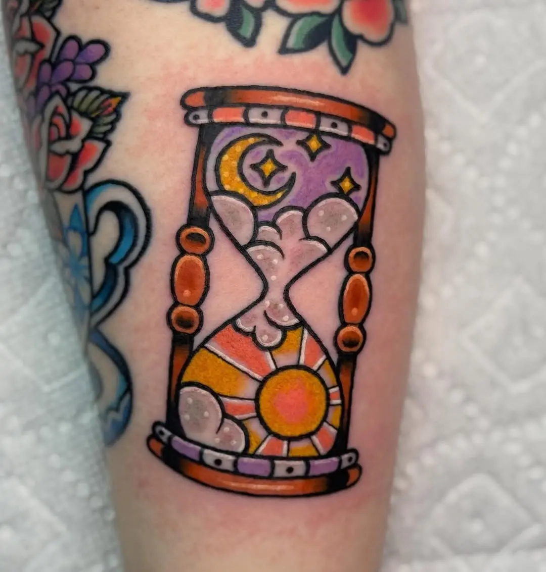 A vibrant hourglass tattoo with cosmic elements