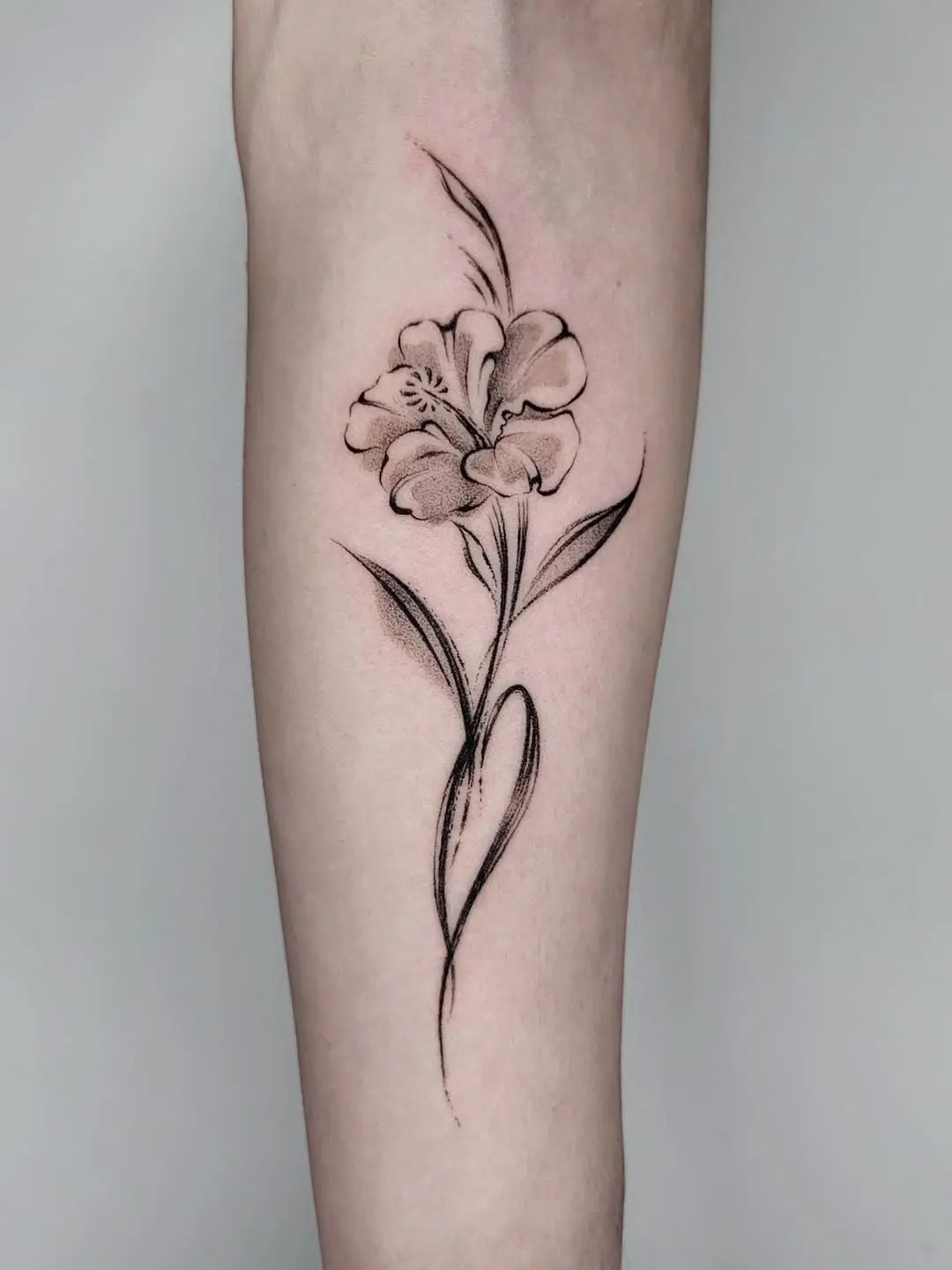 Delicate hibiscus tattoo with graceful lines