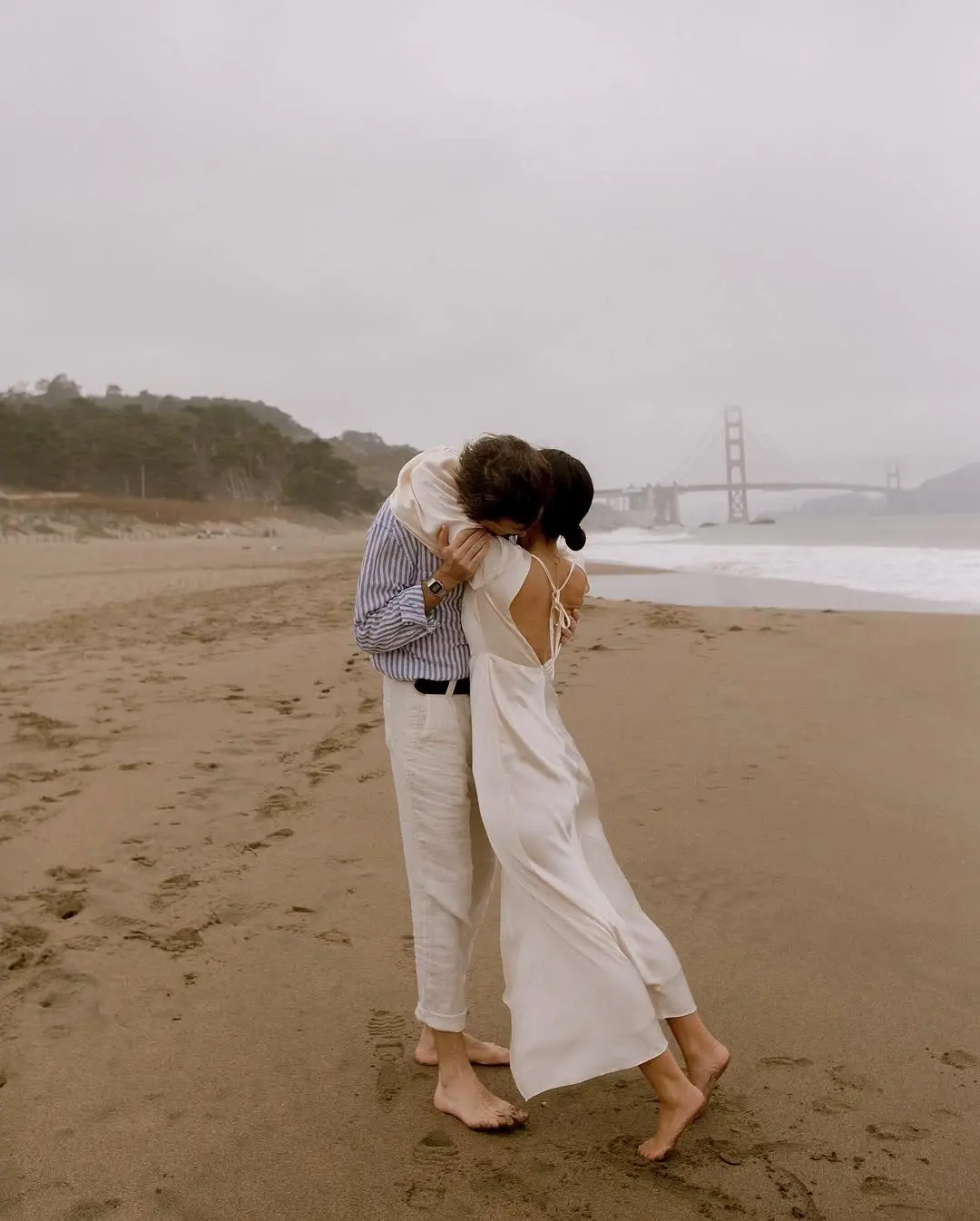 Romantic beach proposal with ocean backdrop