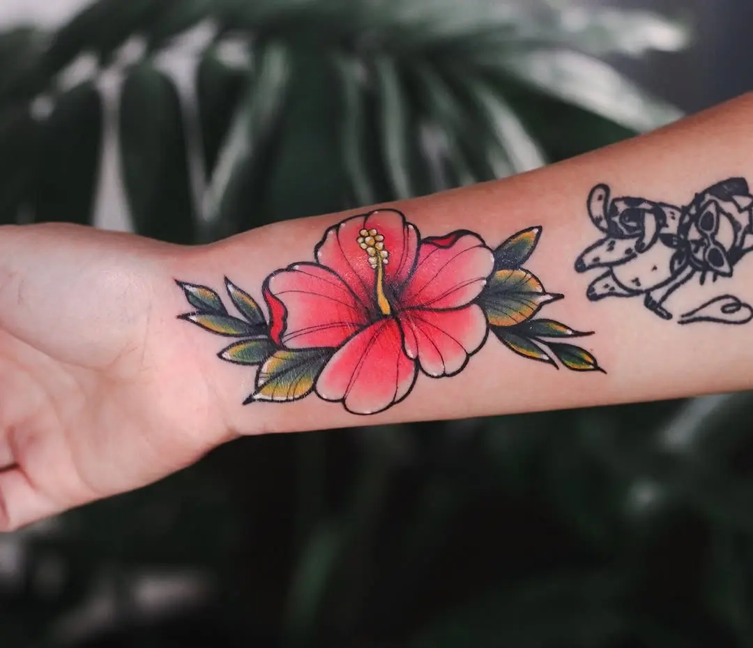 Vibrant hibiscus tattoo on forearm