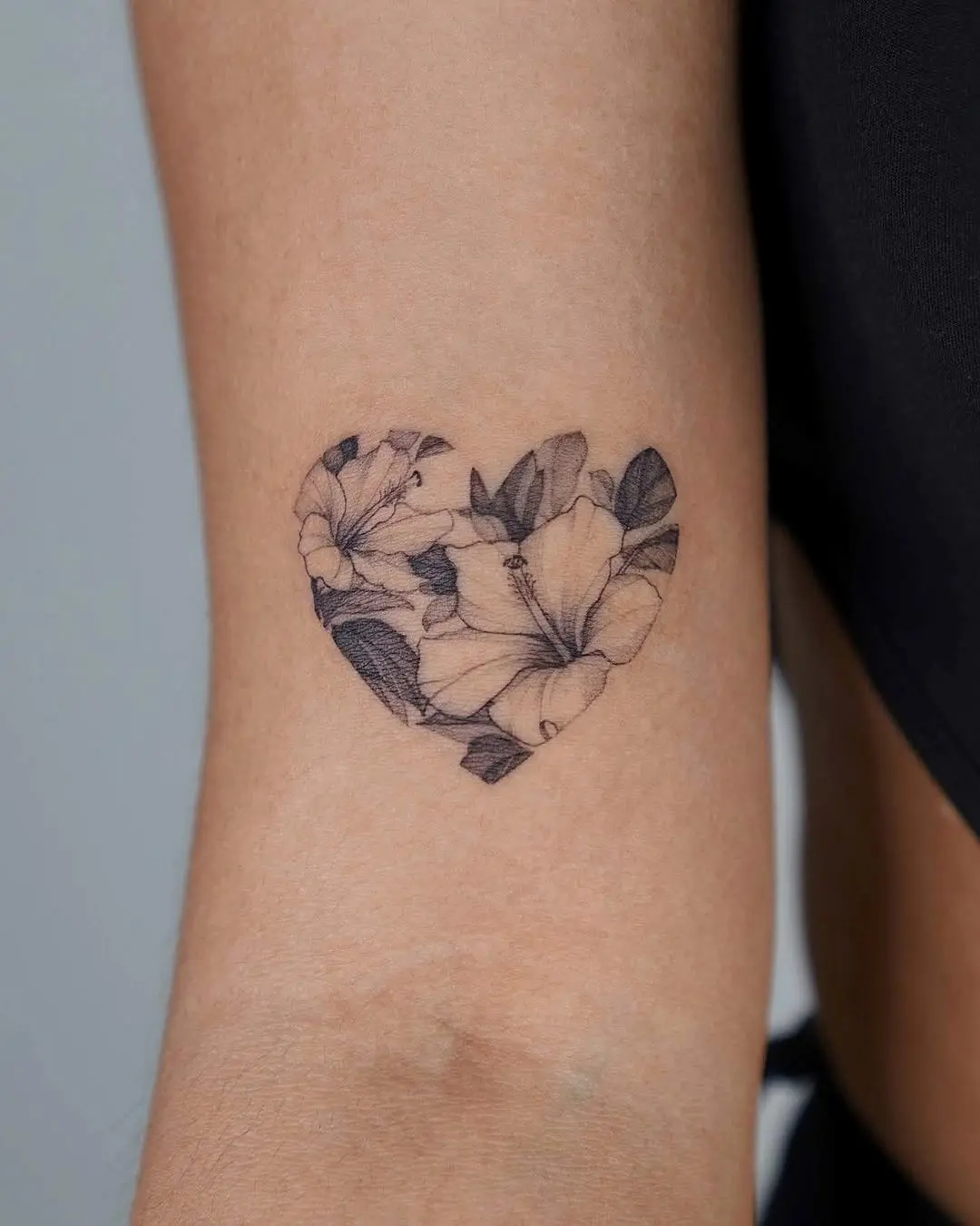 Heart-shaped hibiscus tattoo with floral detailing