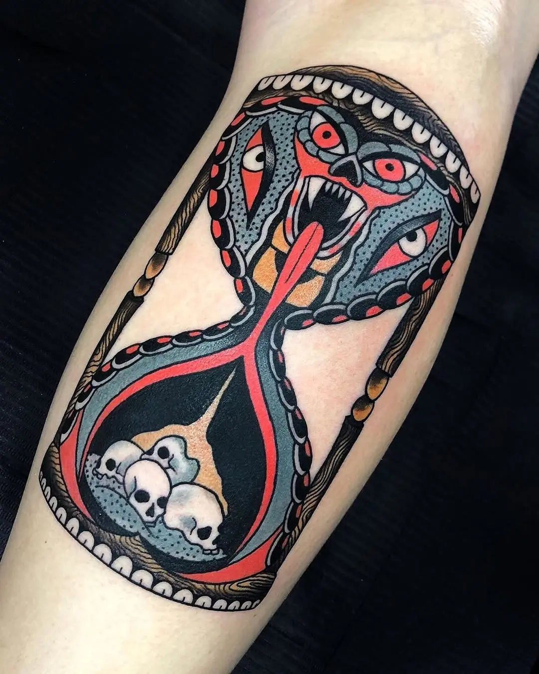 Fierce hourglass tattoo with skull elements