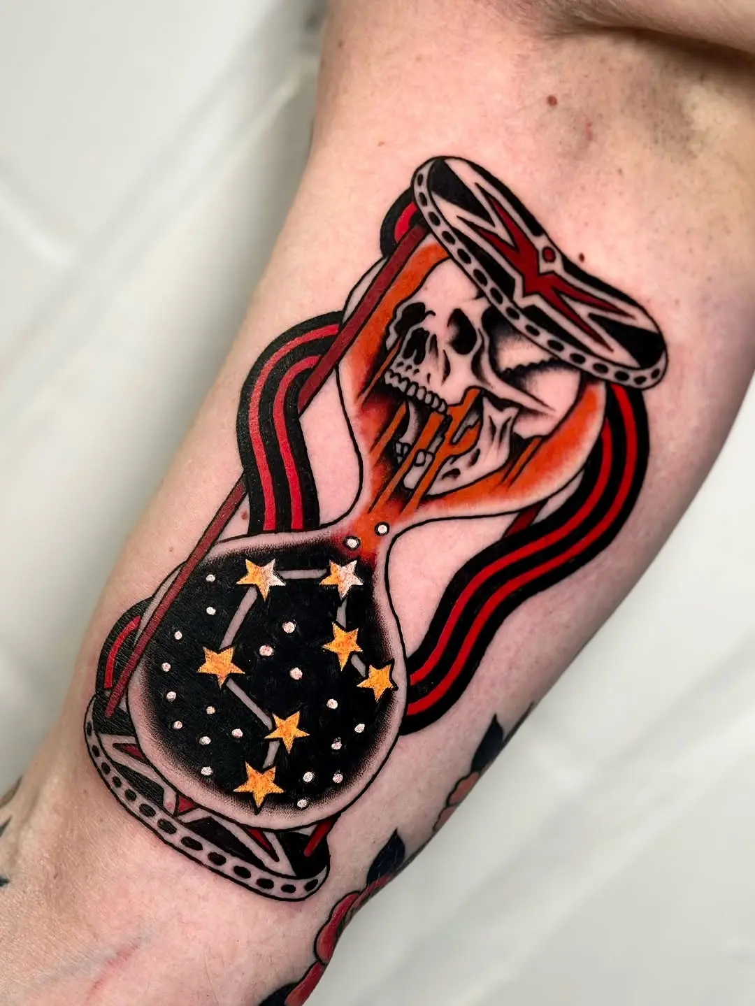 Striking hourglass tattoo with skull imagery