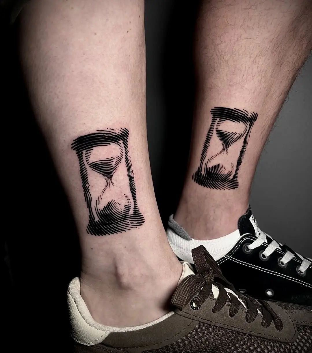 Stylish hourglass tattoos on the lower legs