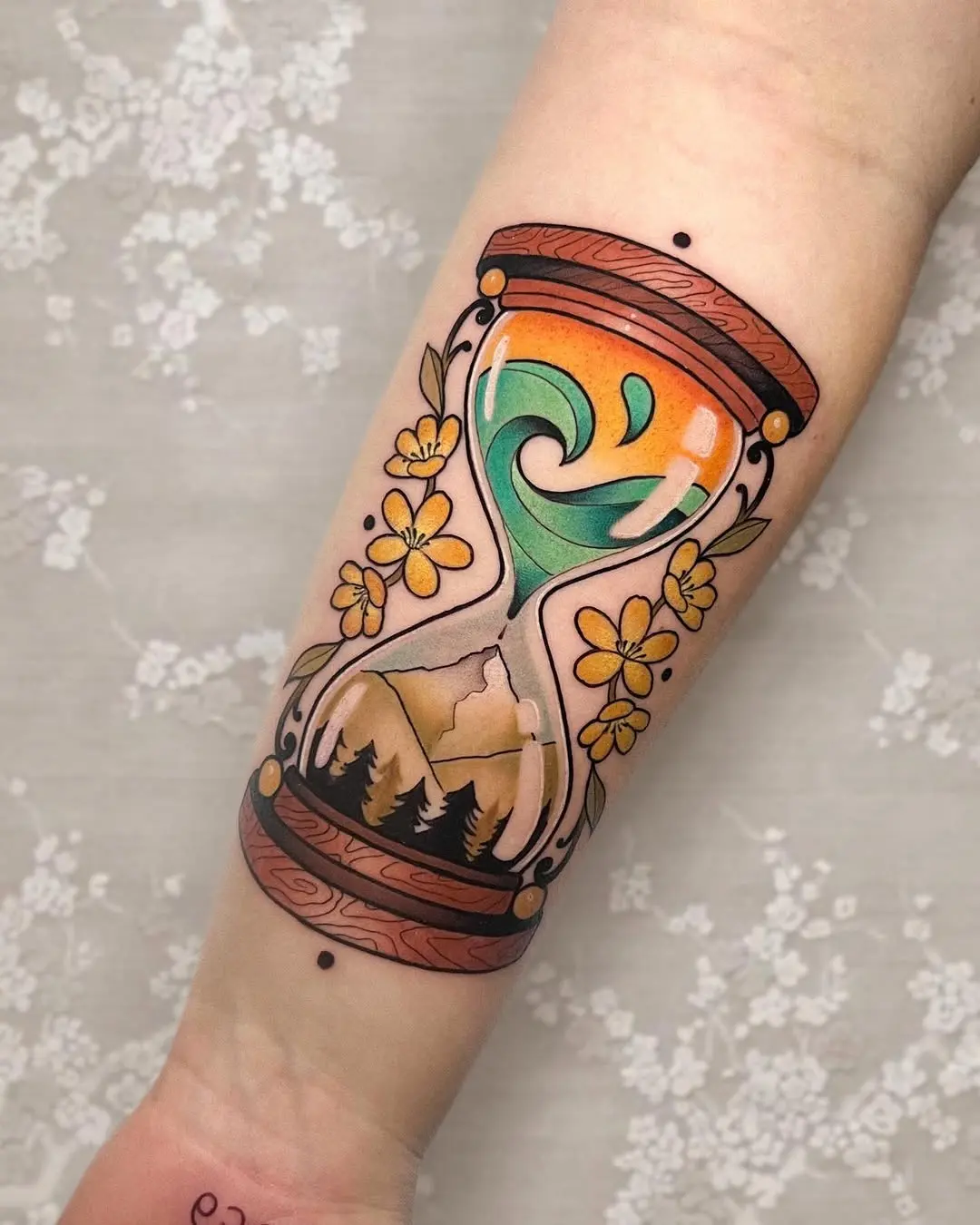 Stunning hourglass tattoo with floral elements