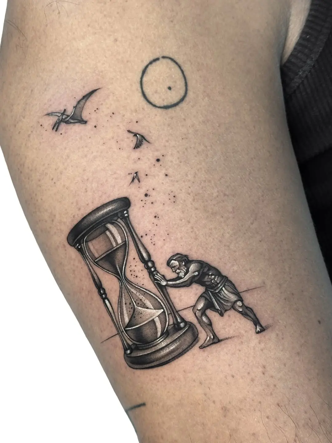Dynamic Hourglass Tattoo with Strong Imagery