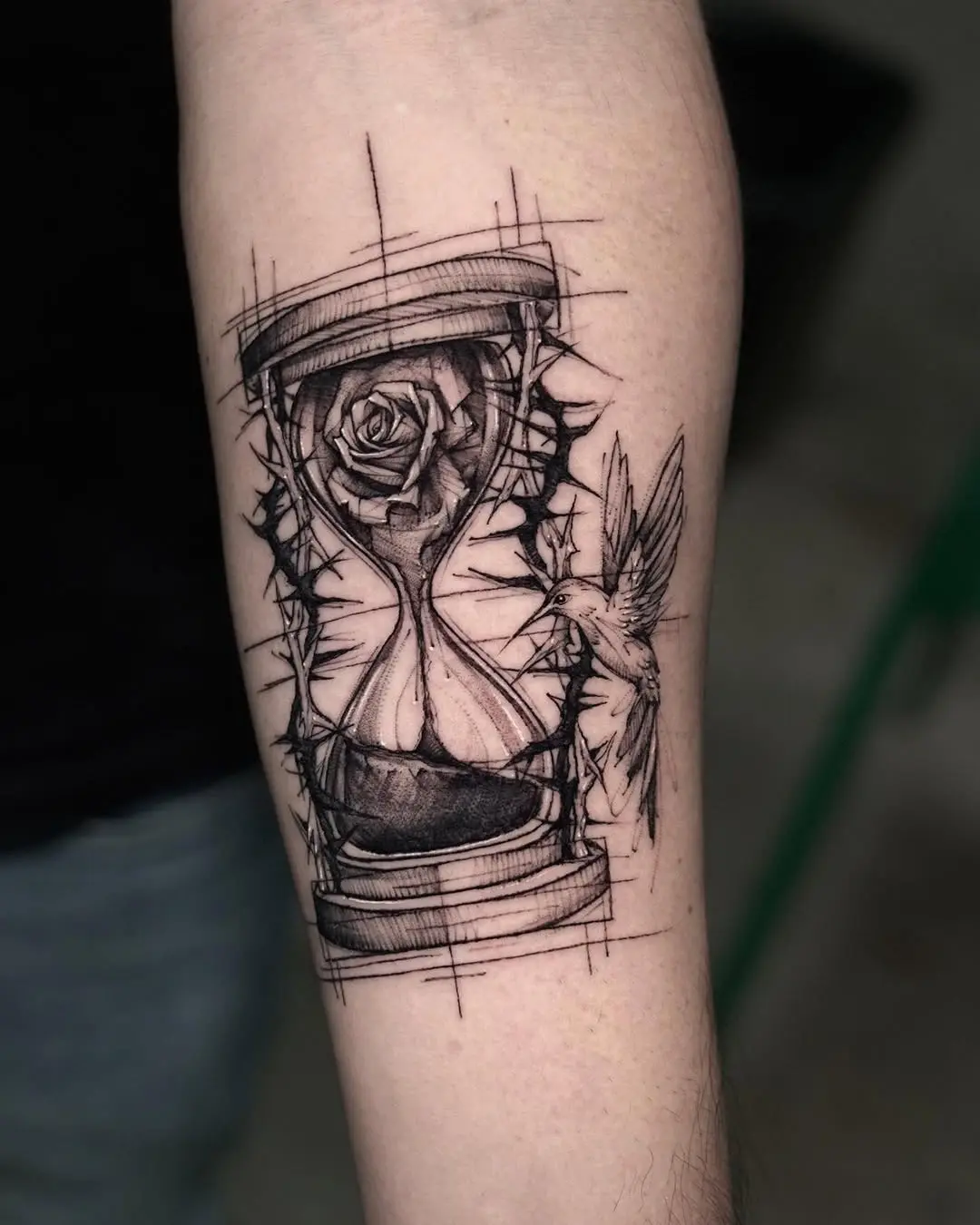 Elegant hourglass tattoo with nature elements