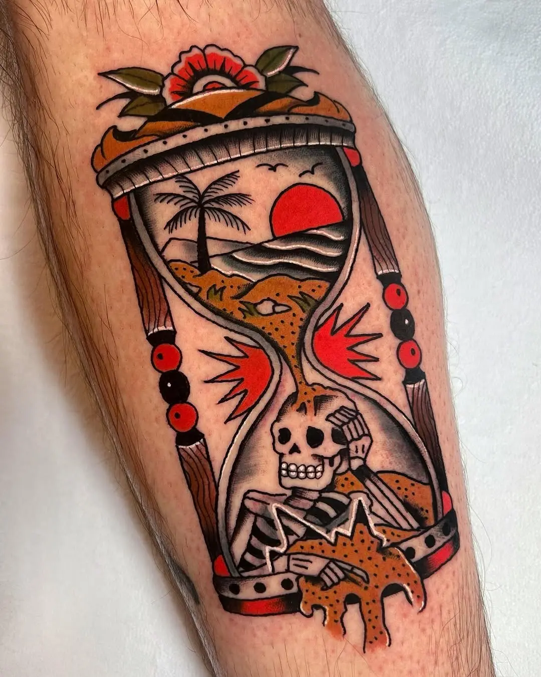 Artistic hourglass tattoo with a skeleton theme