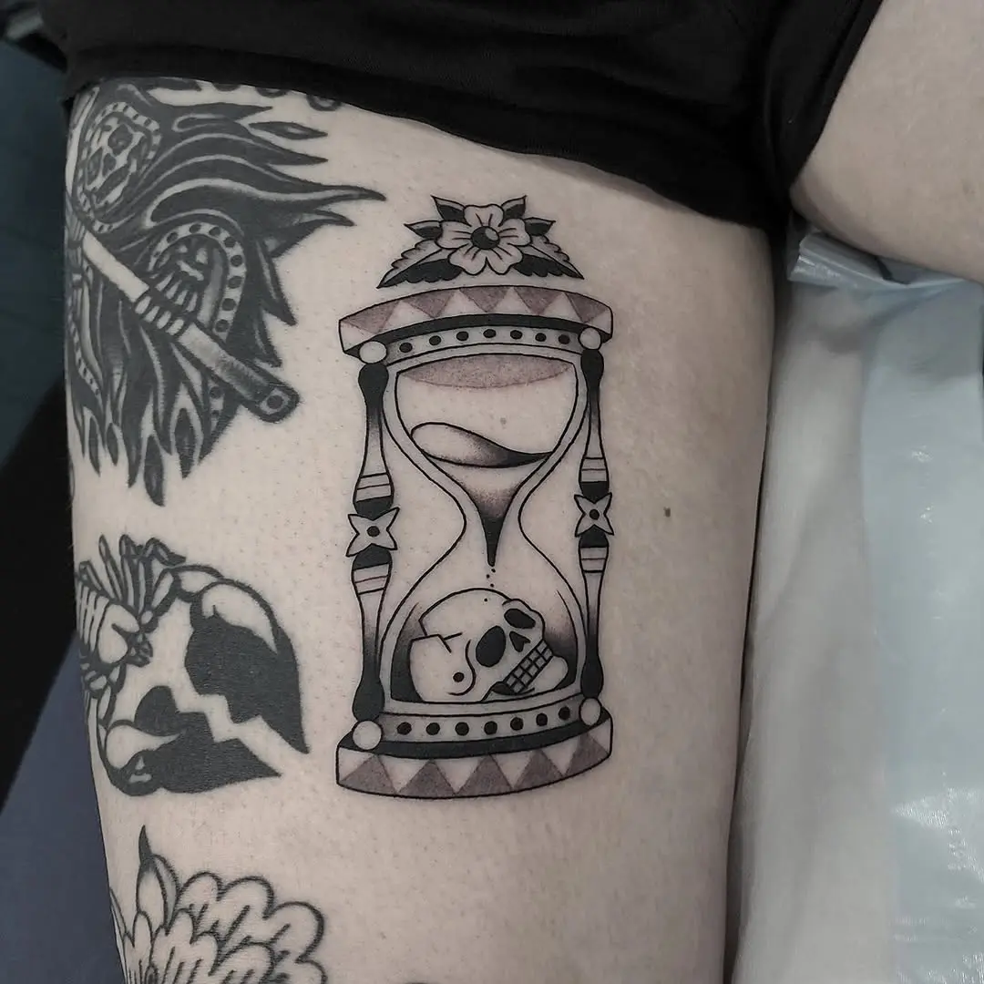 Intricate hourglass tattoo with skull design