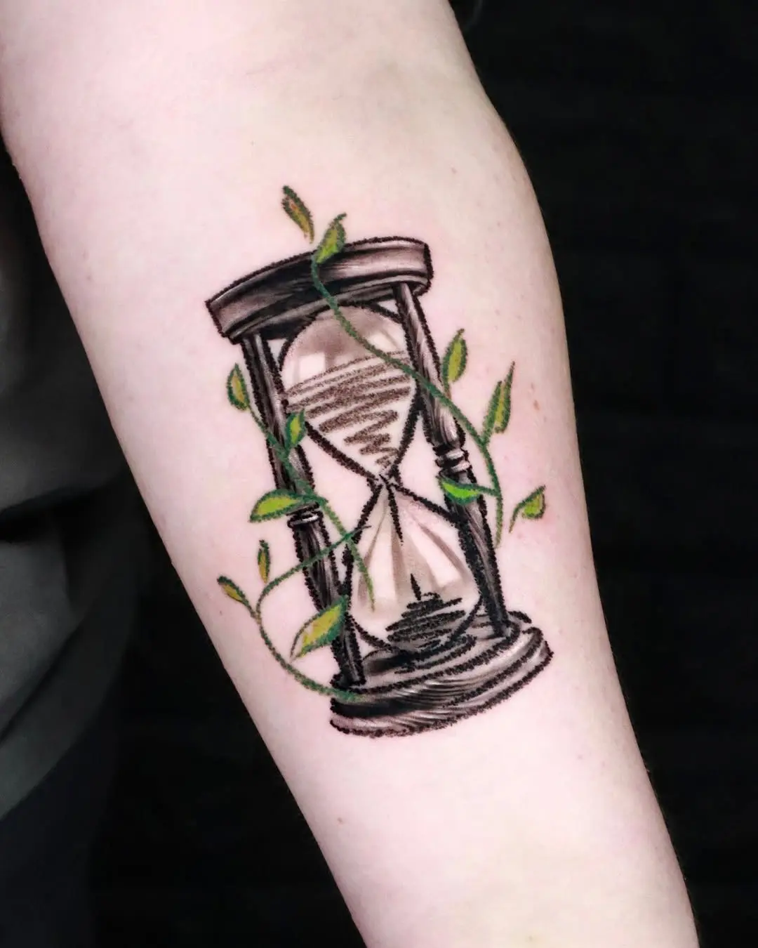 Artistic hourglass tattoo with nature elements