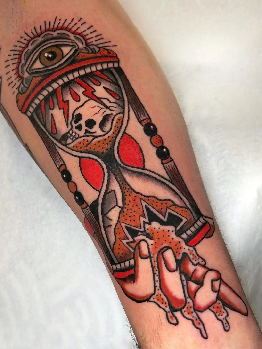 Intricate hourglass tattoo with eye and skull