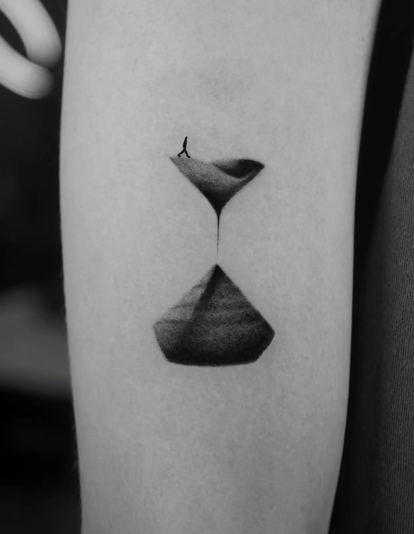 Elegant hourglass tattoo with silhouette detail