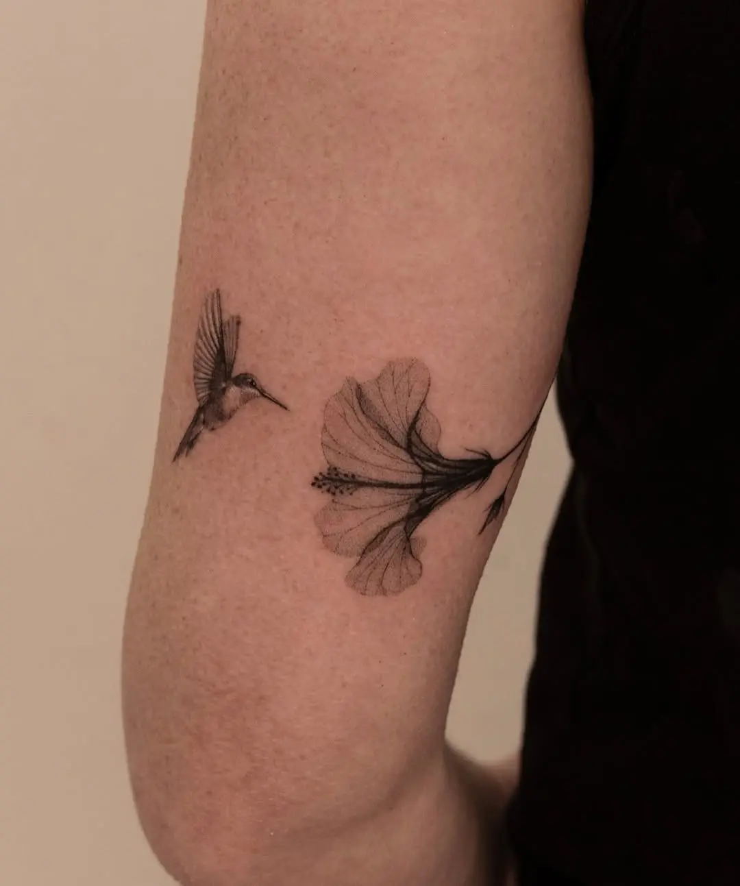 Delicate hummingbird and hibiscus tattoo design