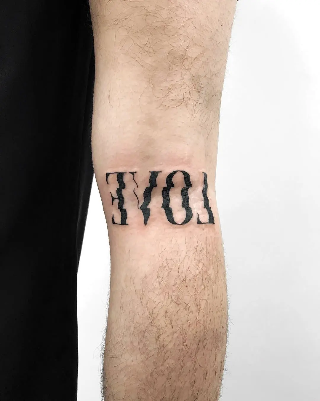 Bold ‘No Love’ Tattoo on Arm