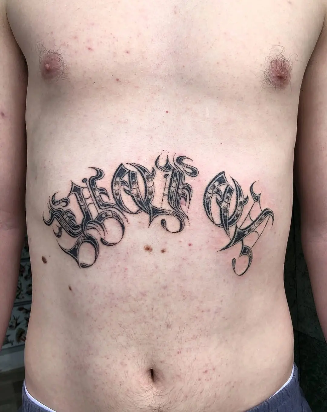 Bold script tattoo expressing personal freedom