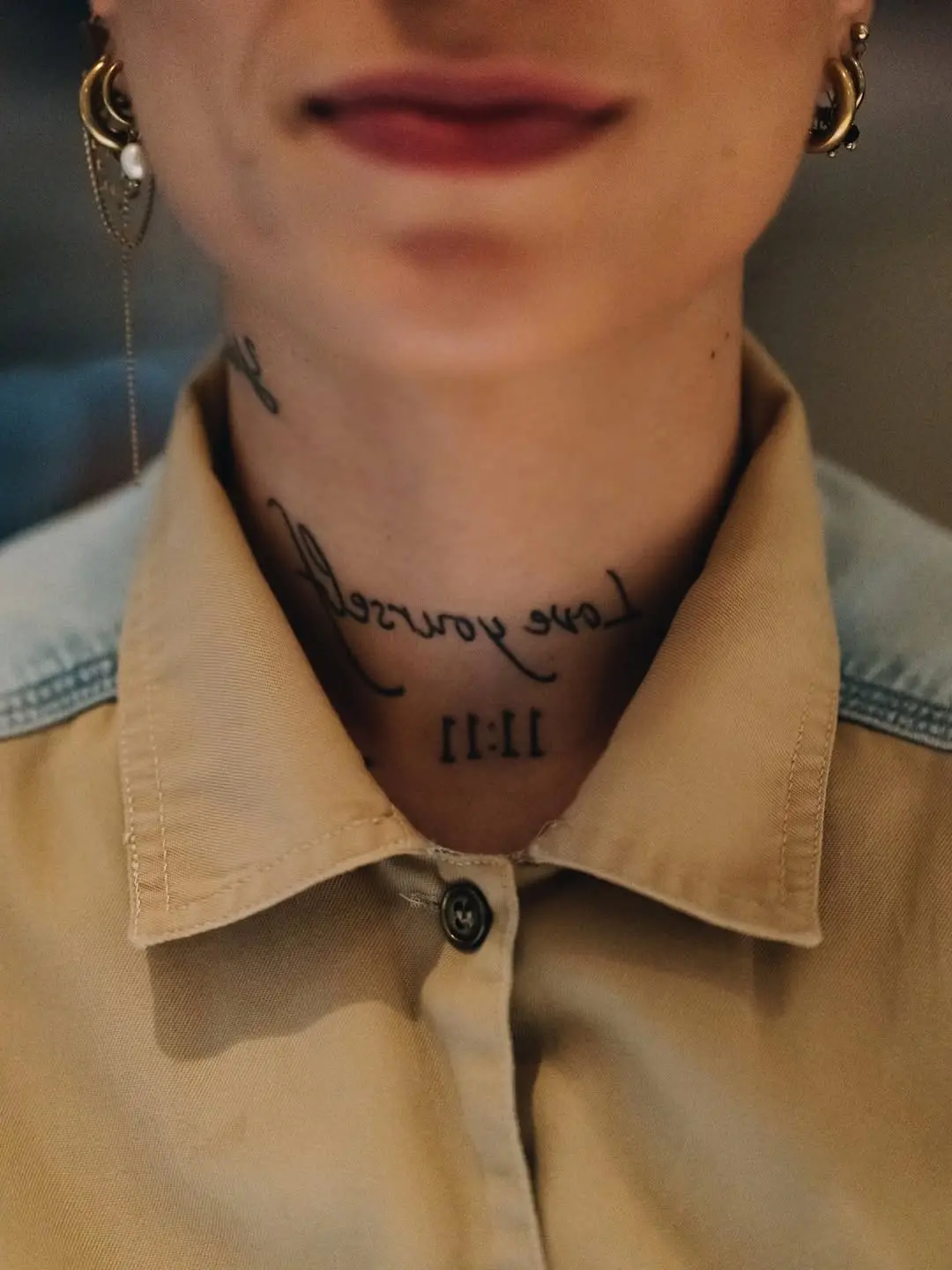 Stylish neck tattoo with a bold message