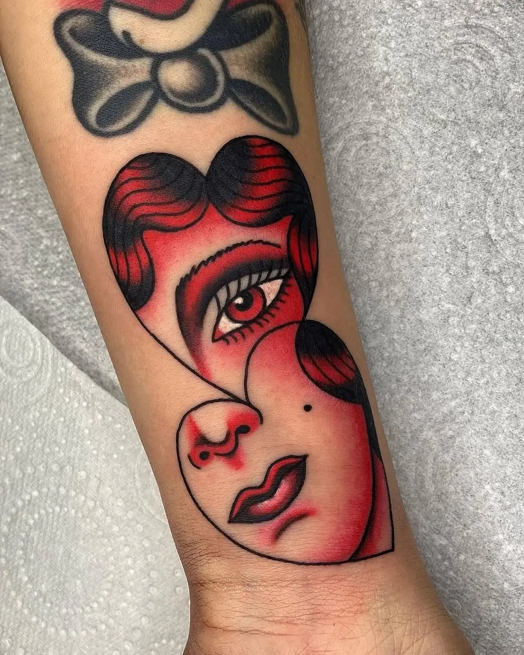 Unique heart-shaped face tattoo design