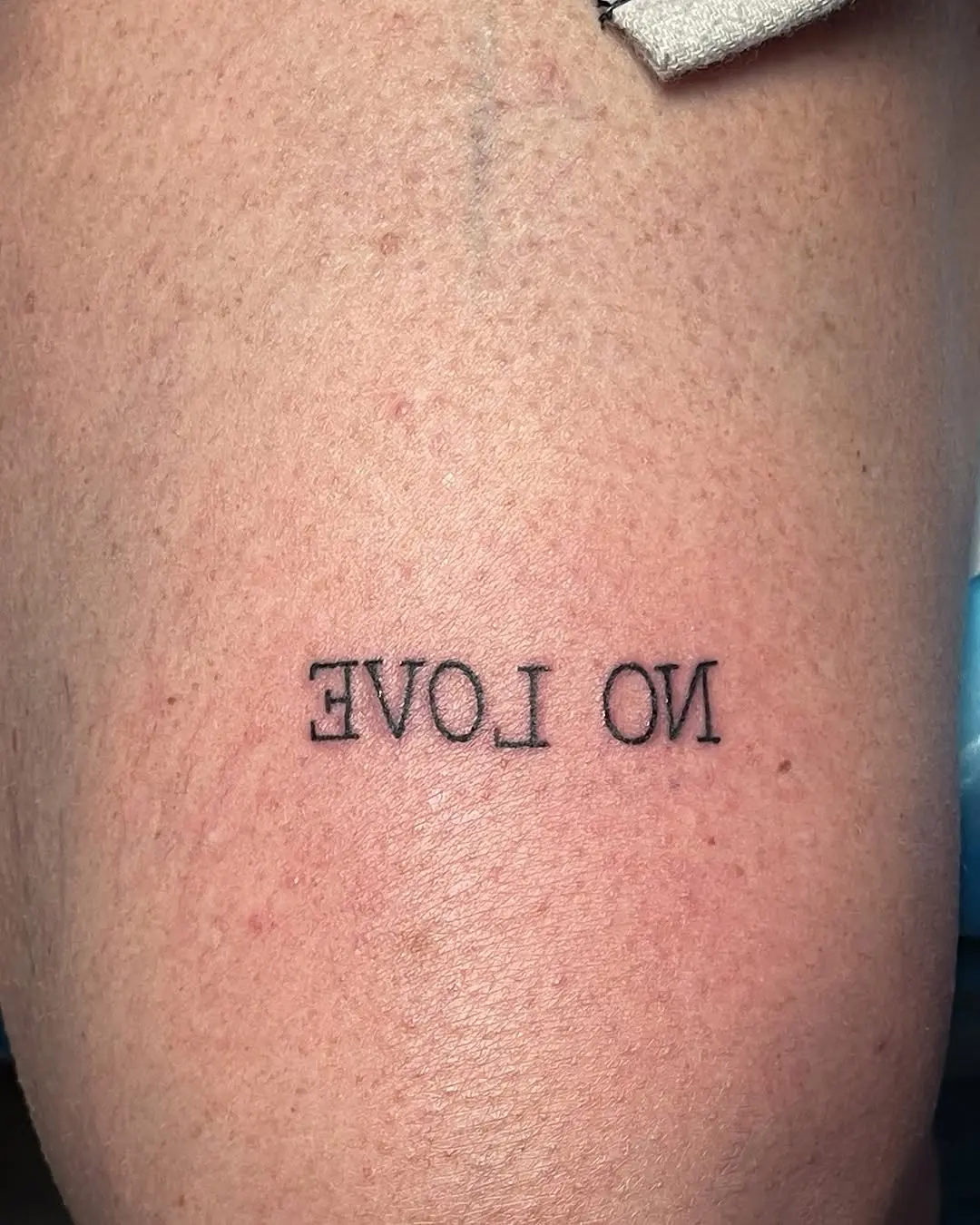 Bold 'No Love' Statement Tattoo on Skin