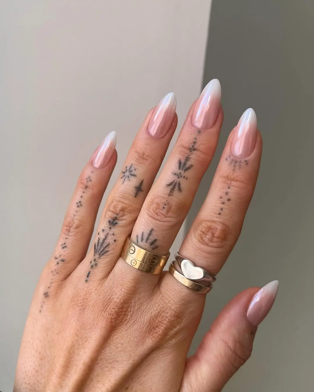 Trendy ombre nails with artistic tattoos