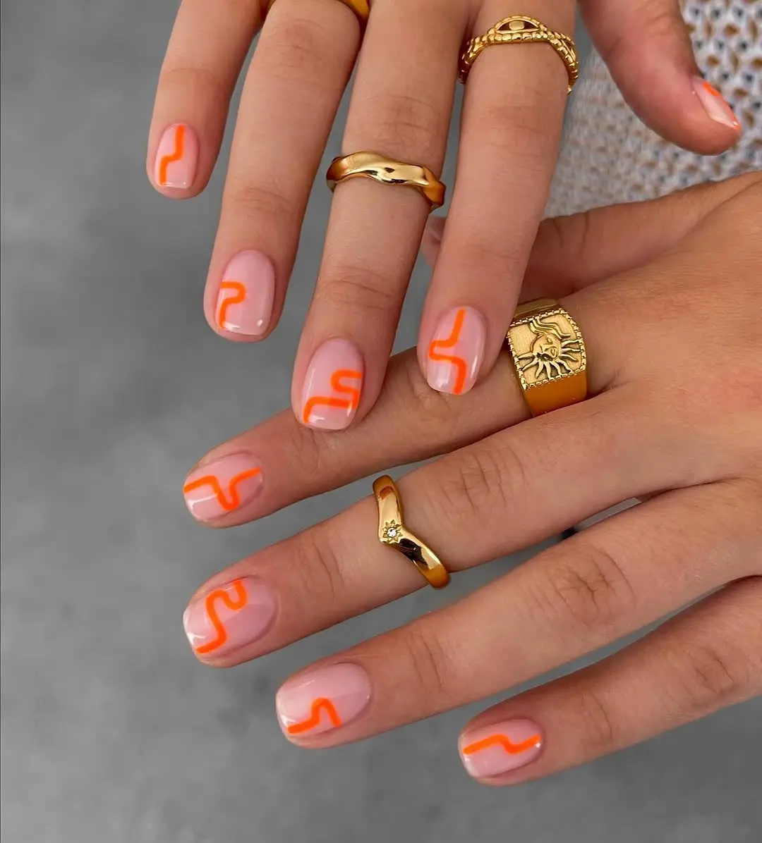 Stylish nails with colorful curves and gold accents