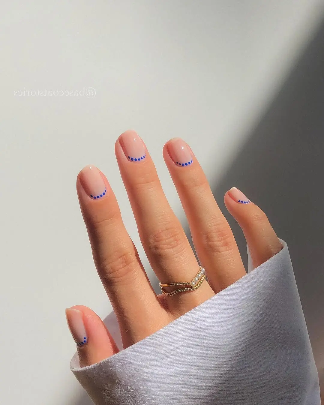 Minimalistic nails with simple blue dot patterns
