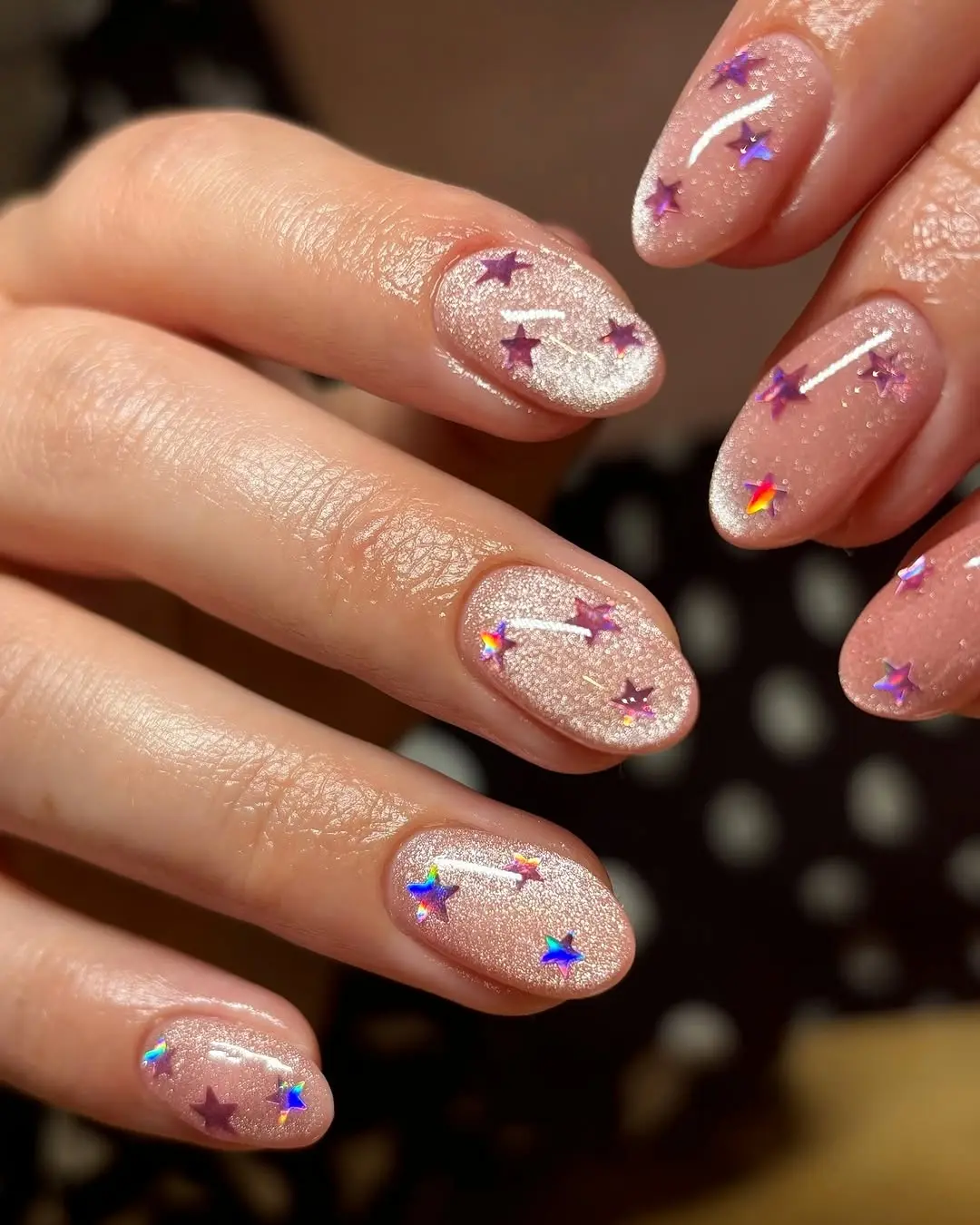 Shimmering pink nails with starry details