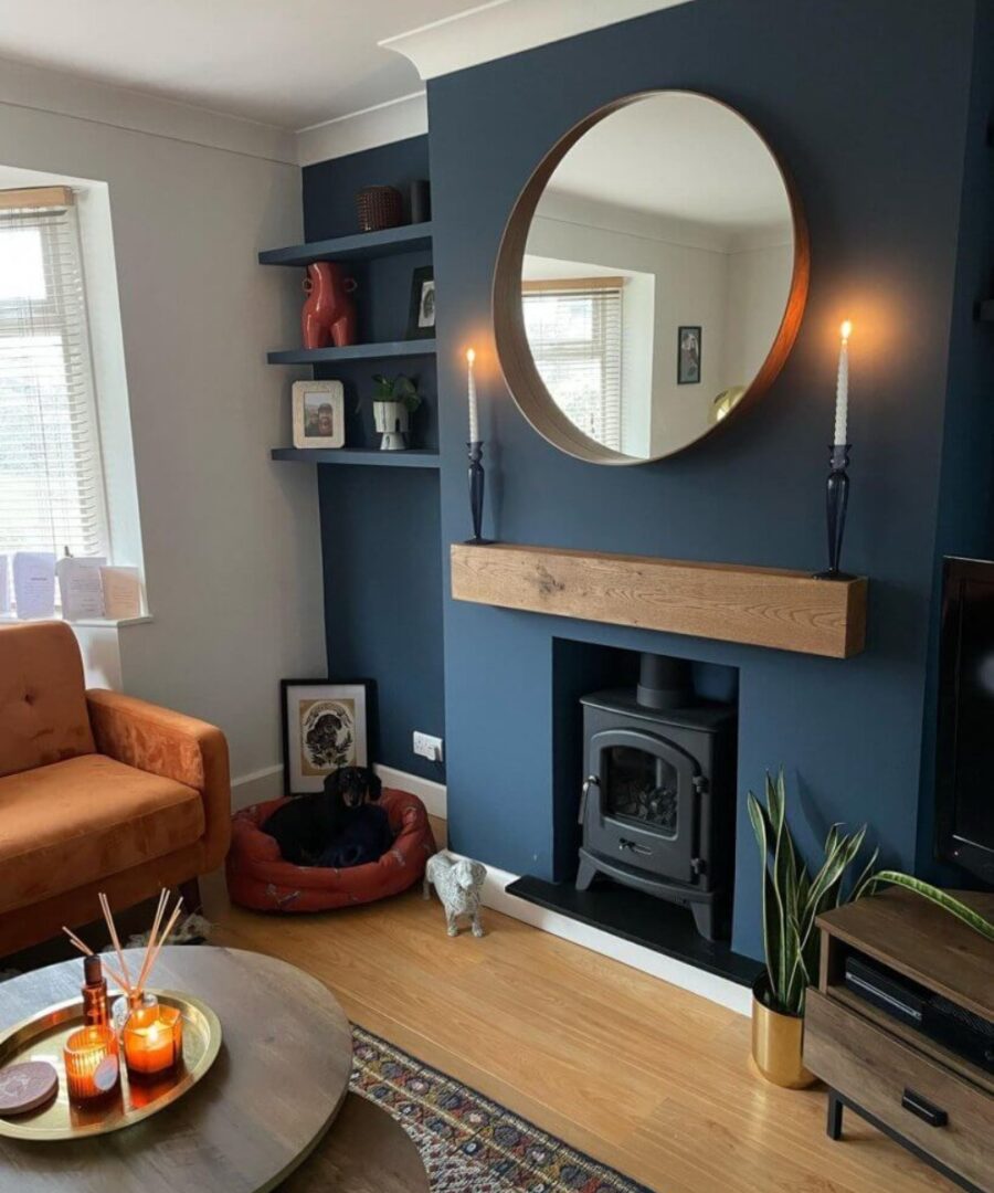 Stylish blue accent wall with circular mirror