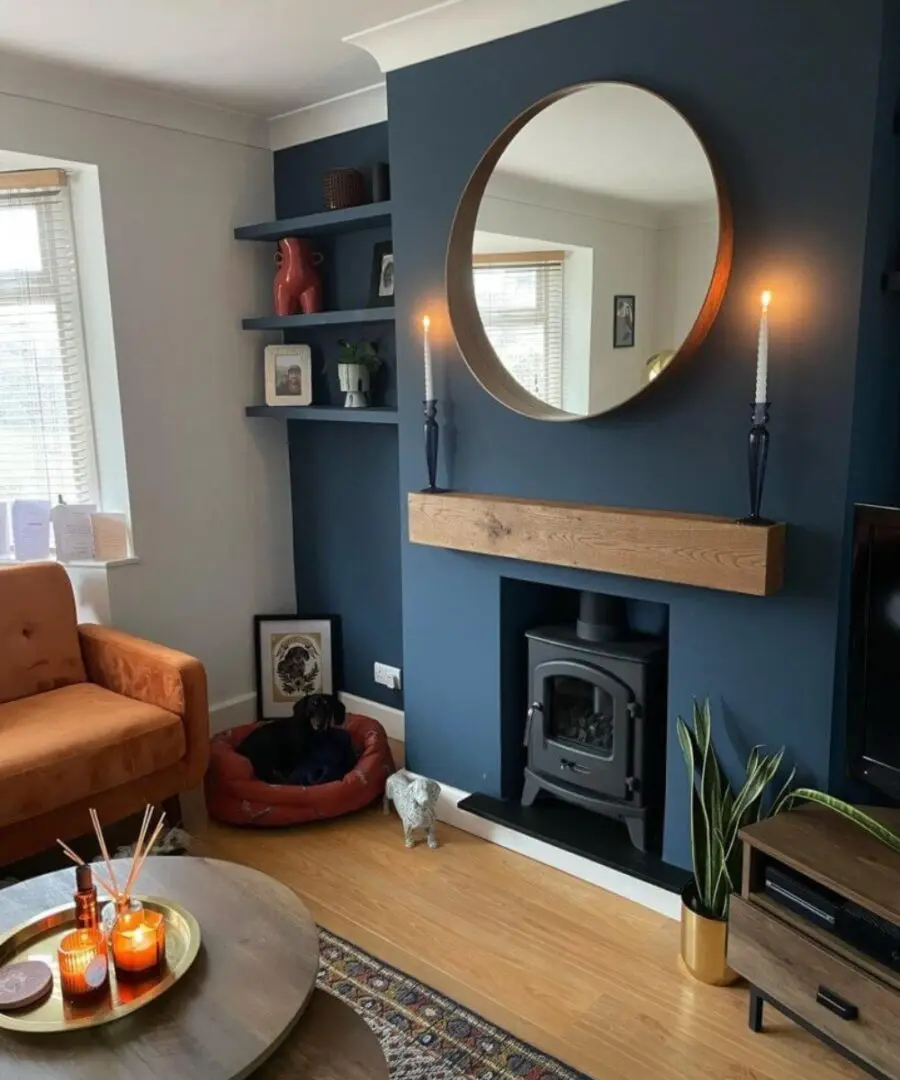 Stylish blue accent wall with circular mirror