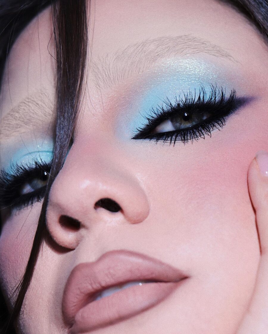 Striking baby blue eye makeup with nude lips