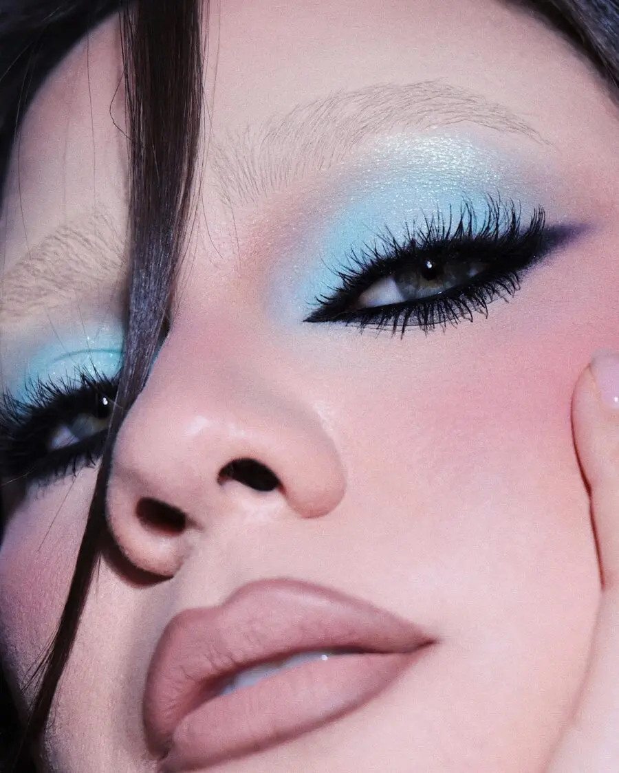 Striking baby blue eye makeup with nude lips