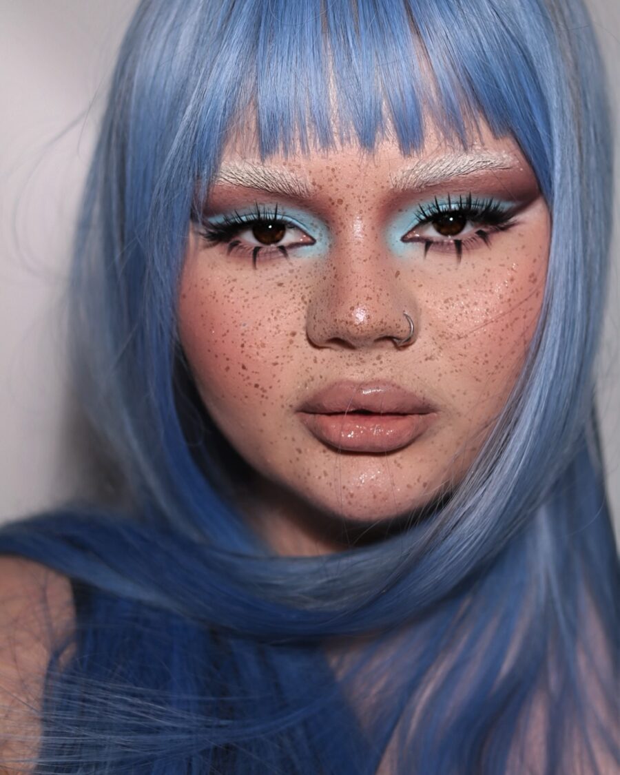 Vibrant baby blue makeup with stunning freckles