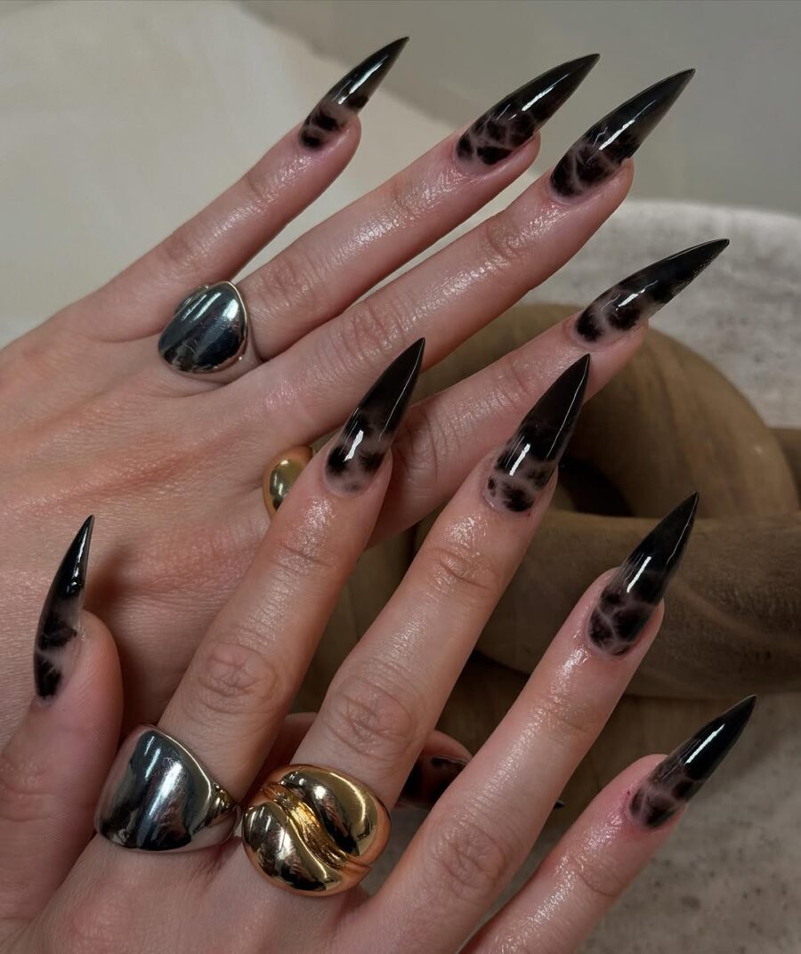 Edgy black stiletto nails with smoky accents