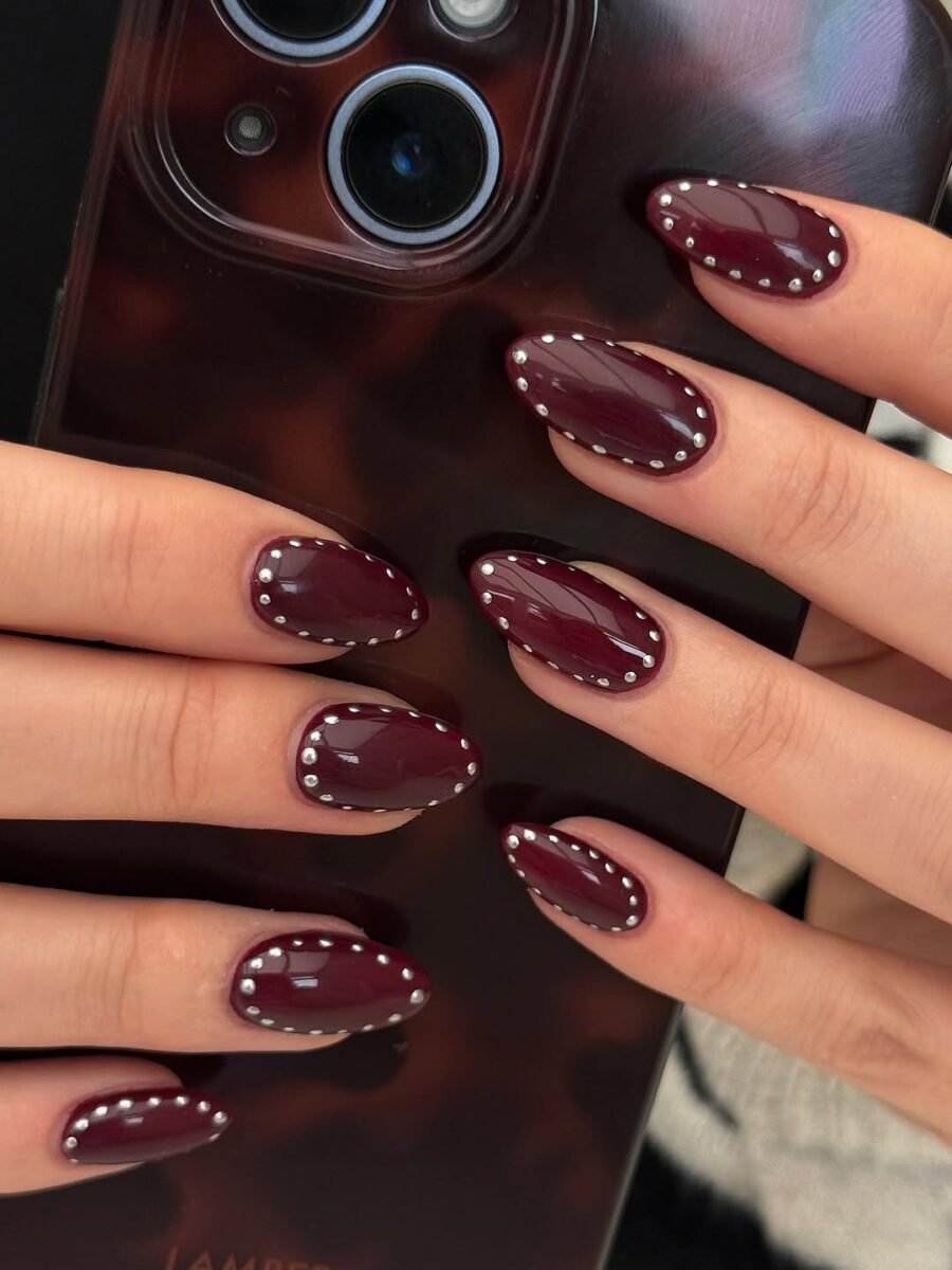 Elegant burgundy nails with stylish stud accents