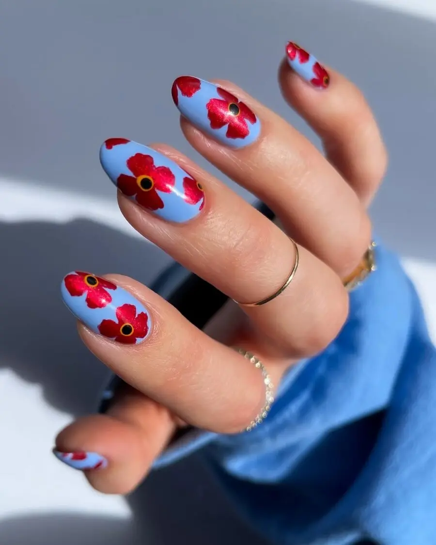Beautiful blue nails adorned with red flowers