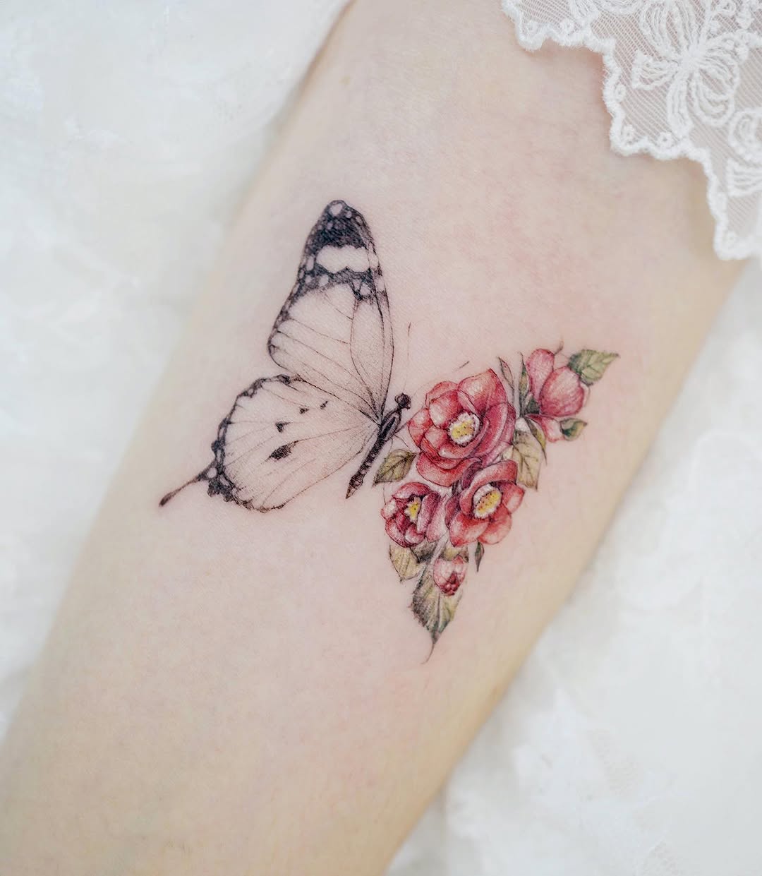 Delicate butterfly and camellia flower tattoo design