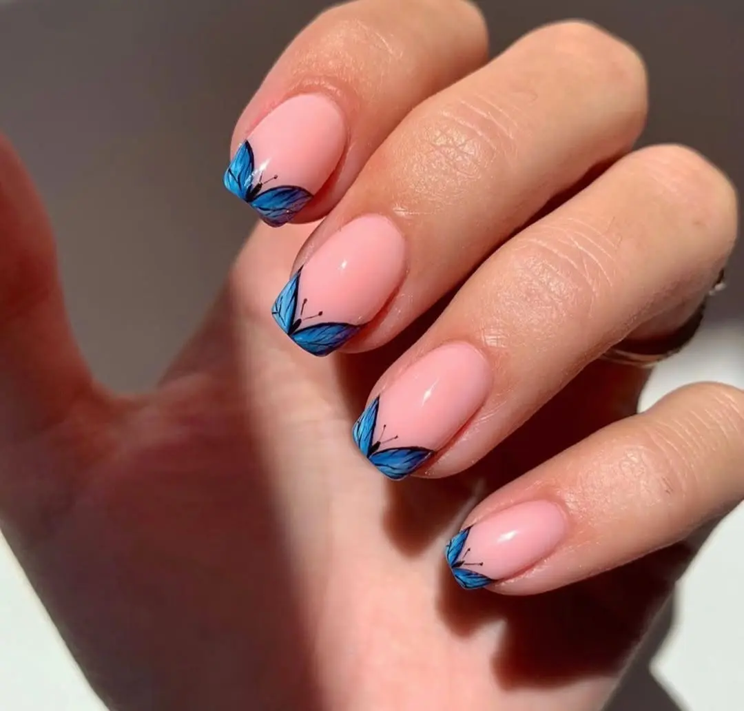 Stunning butterfly nail art with blue accents