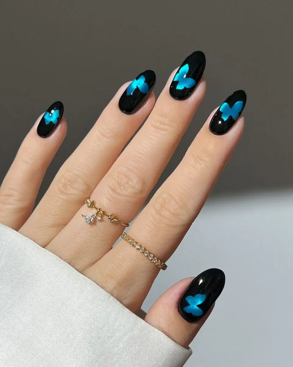 Elegant butterfly design on sleek black nails