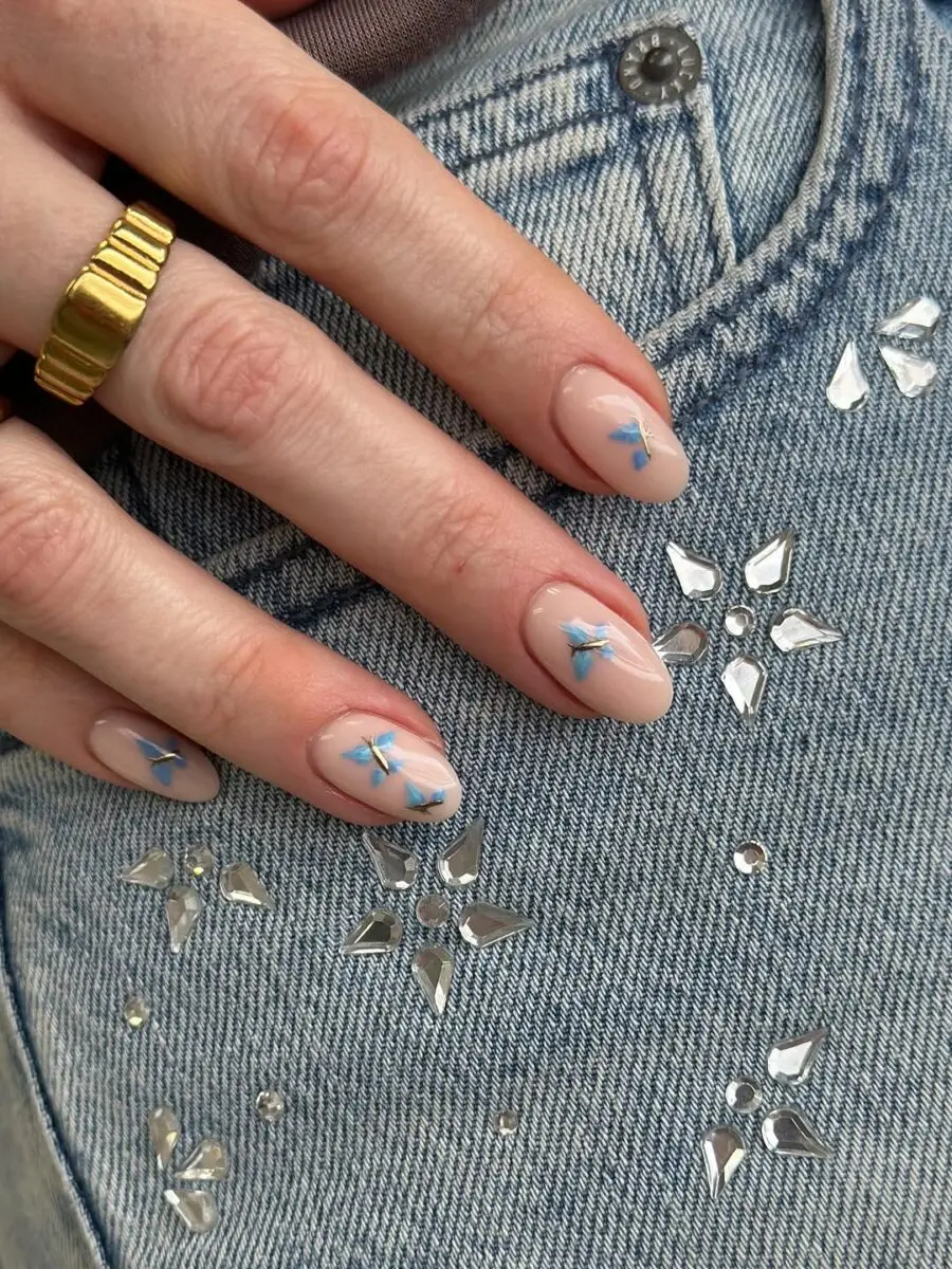 Stylish butterfly nails with blue accents