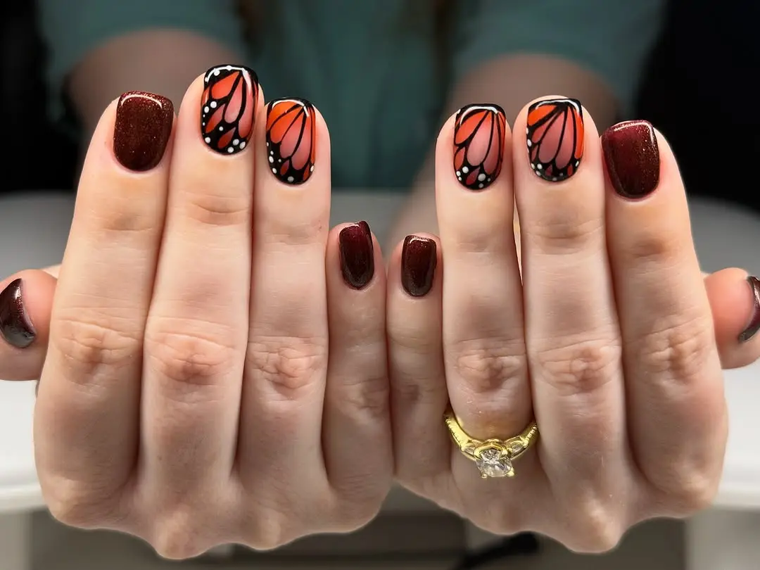Vibrant butterfly nail art with sparkly accents