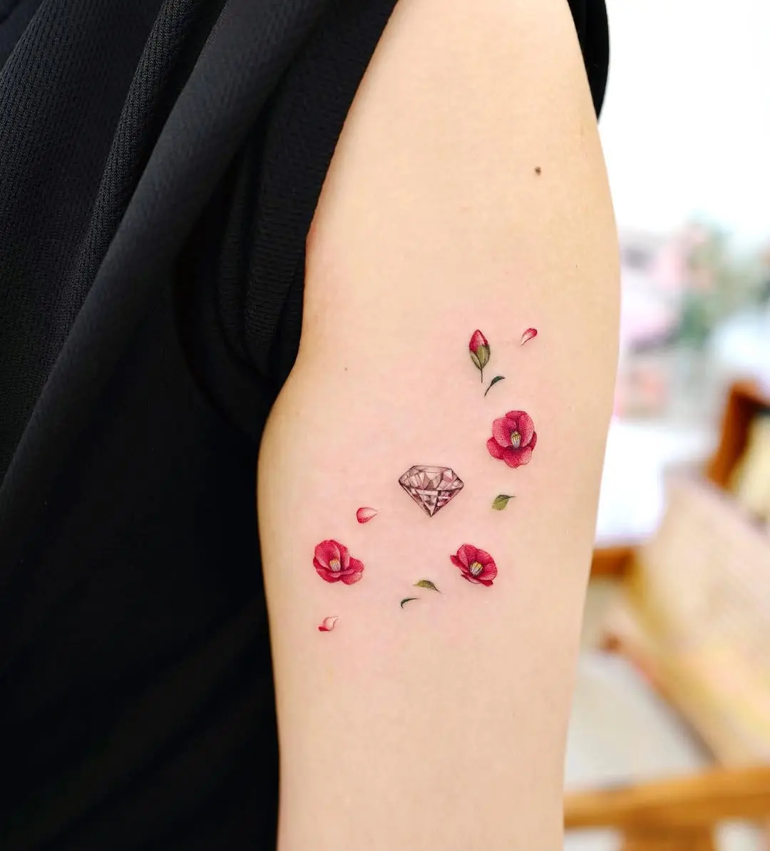 Elegant camellia tattoo with a diamond accent