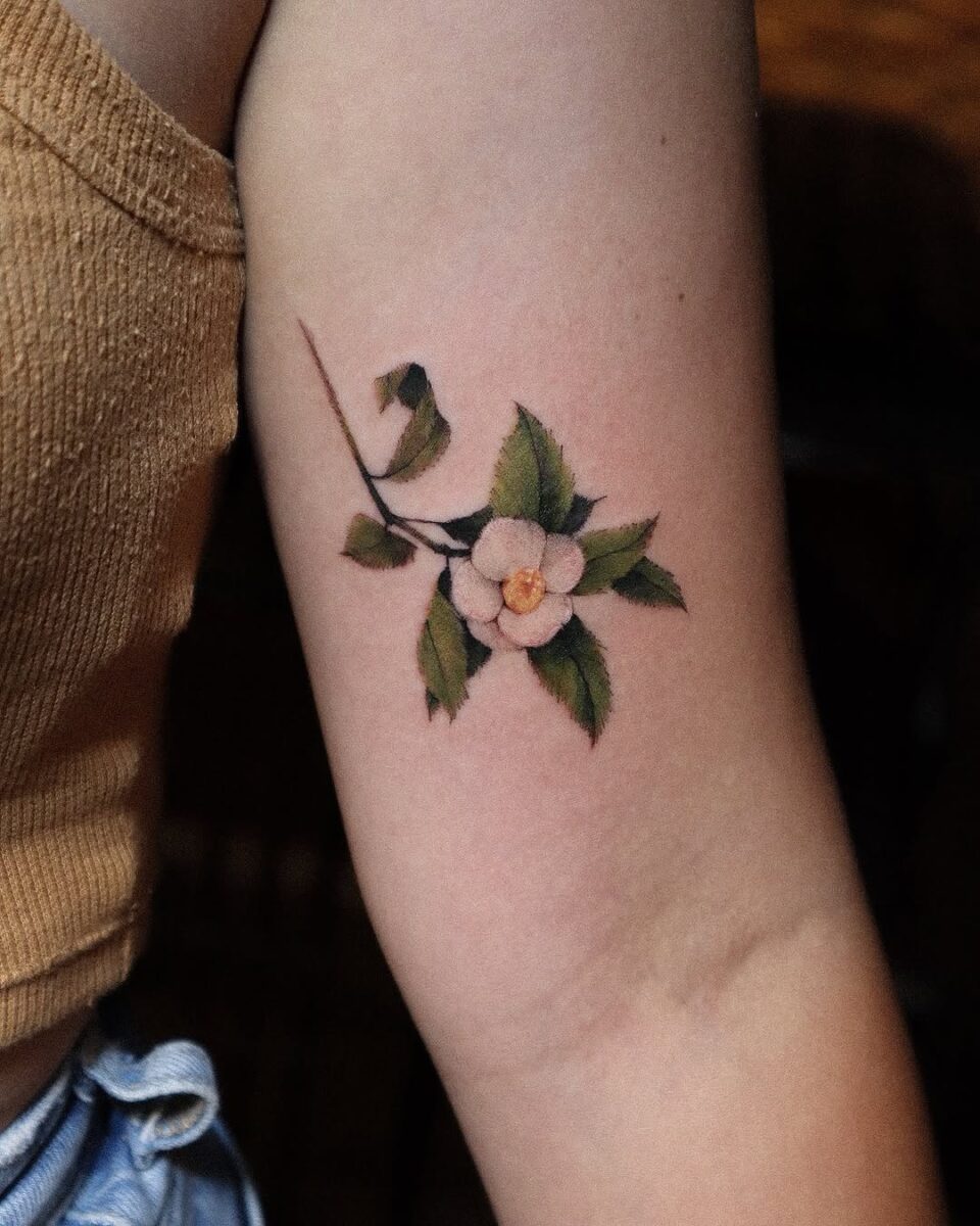 Stunning camellia tattoo on the arm