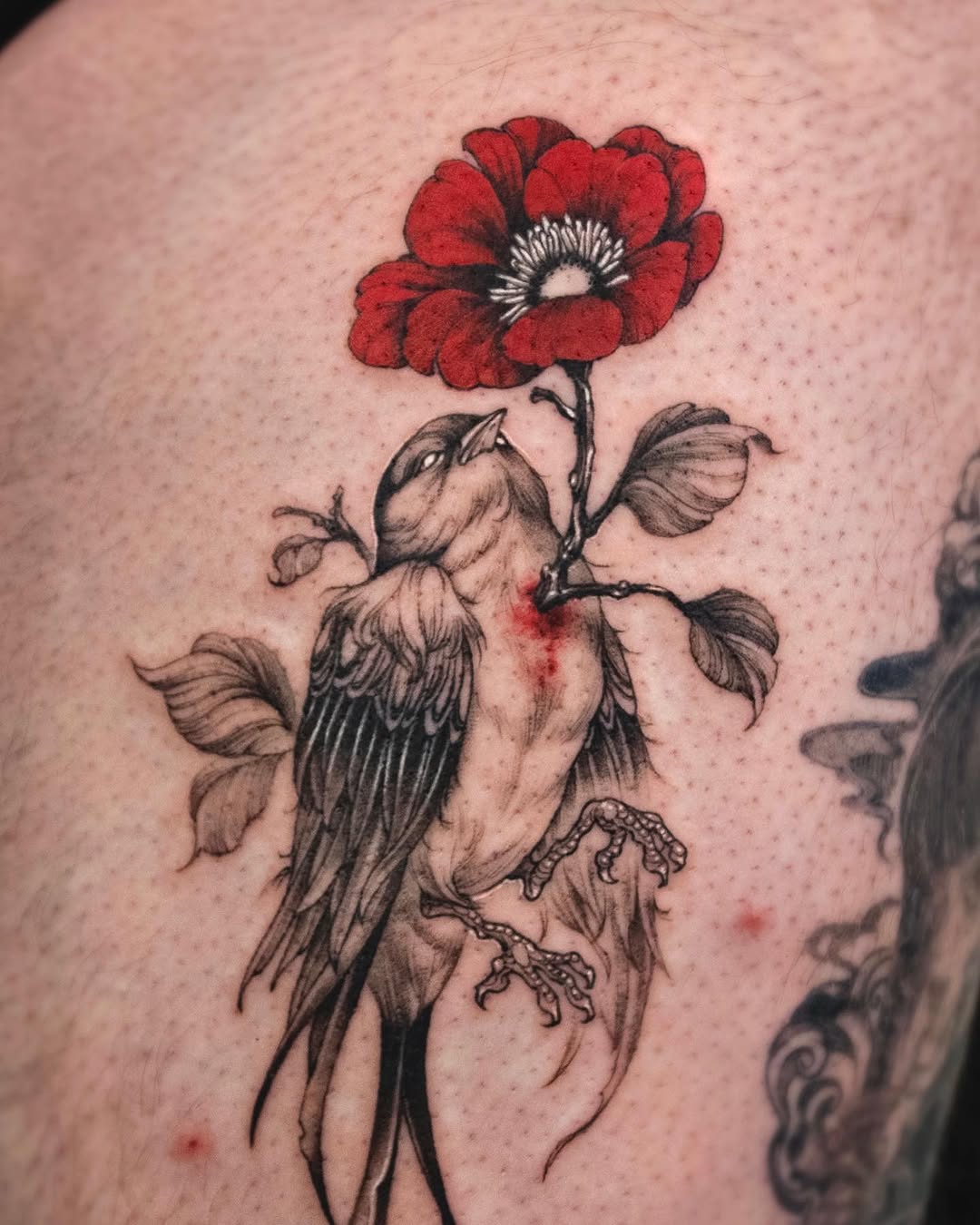 Elegant bird tattoo with striking camellia flower