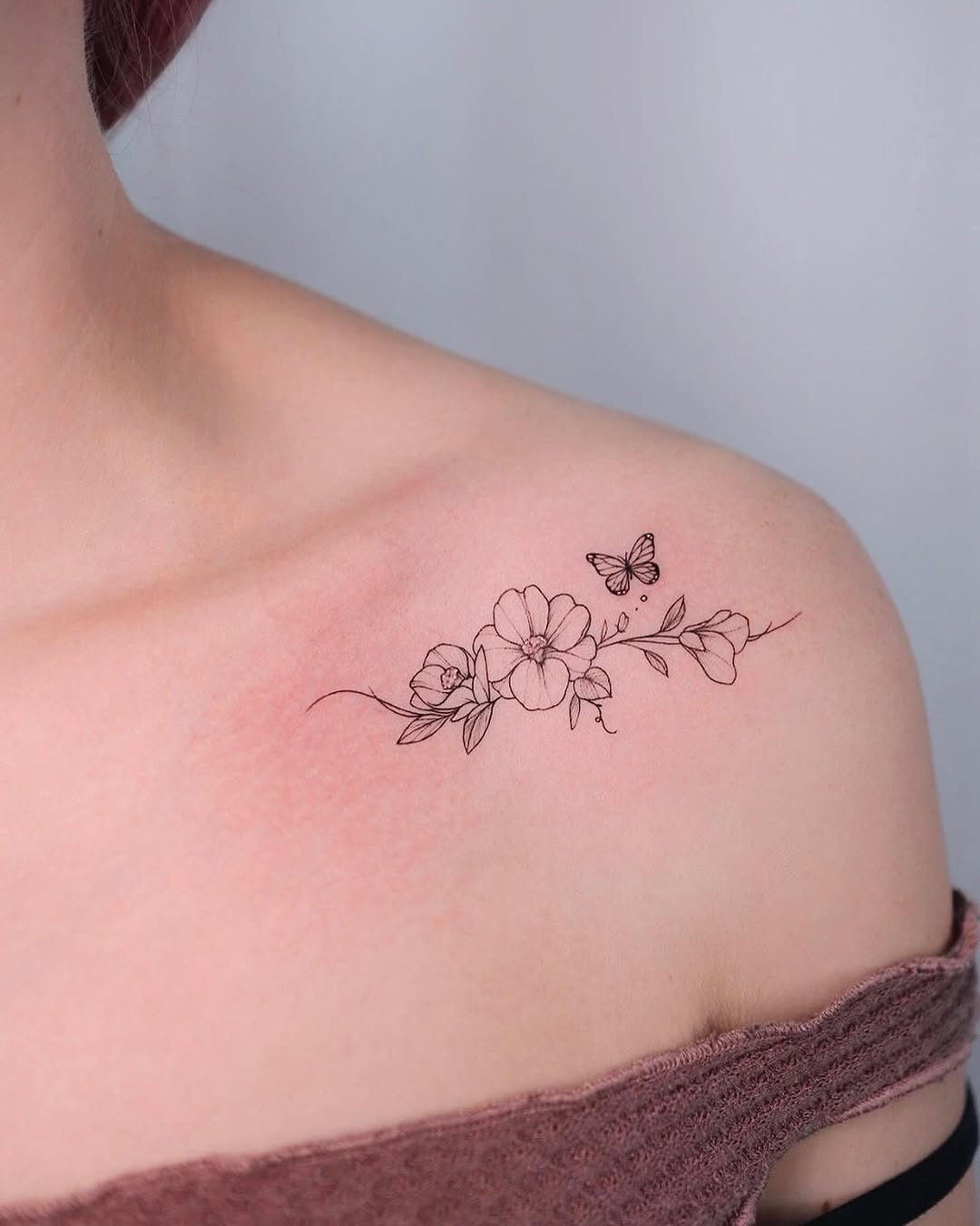 Elegant camellia tattoo with delicate butterfly detail