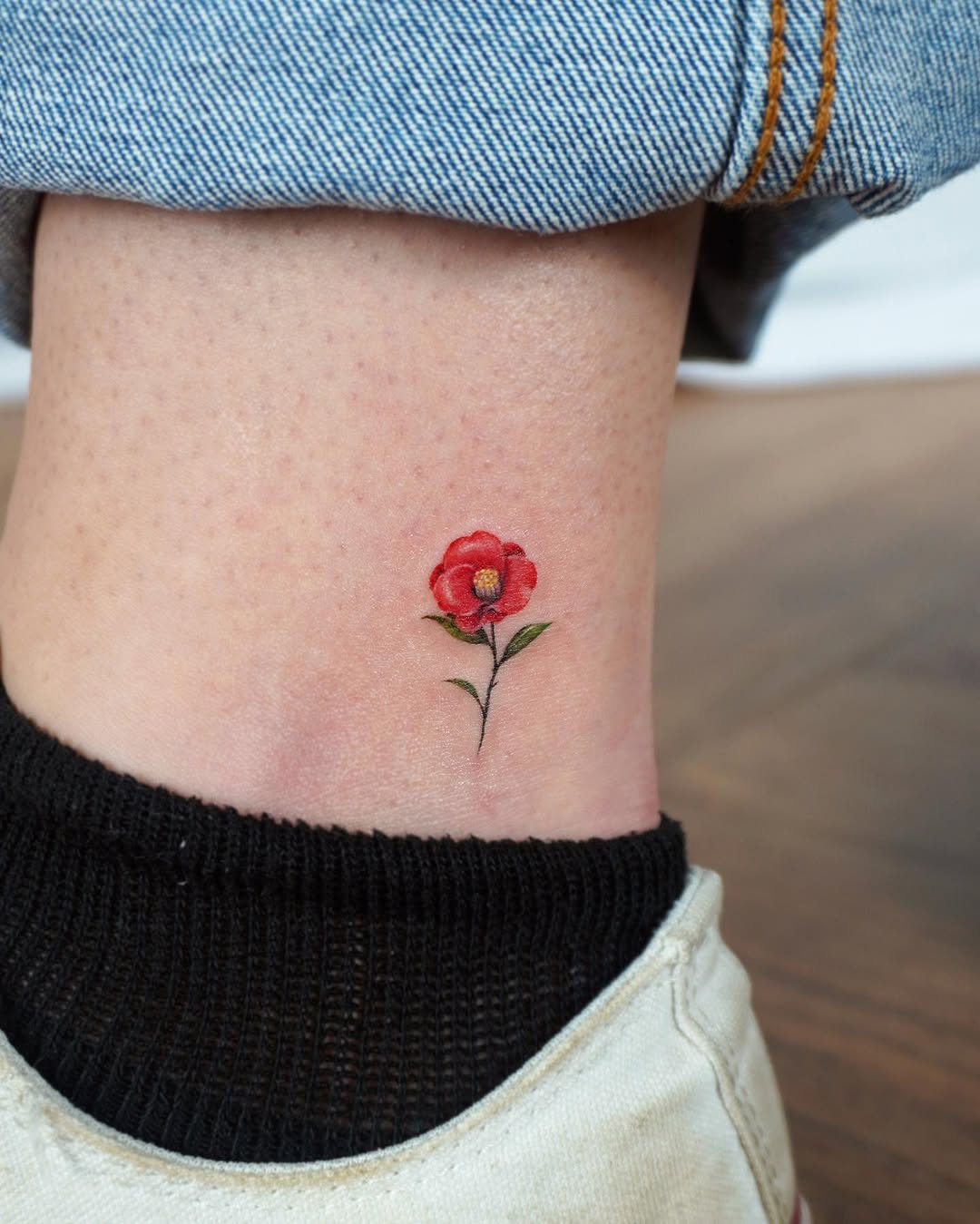 Charming camellia tattoo on ankle