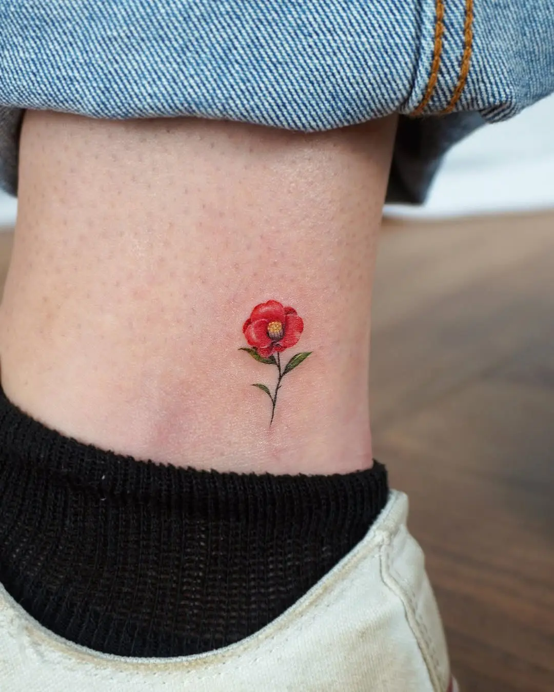 Charming camellia tattoo on ankle