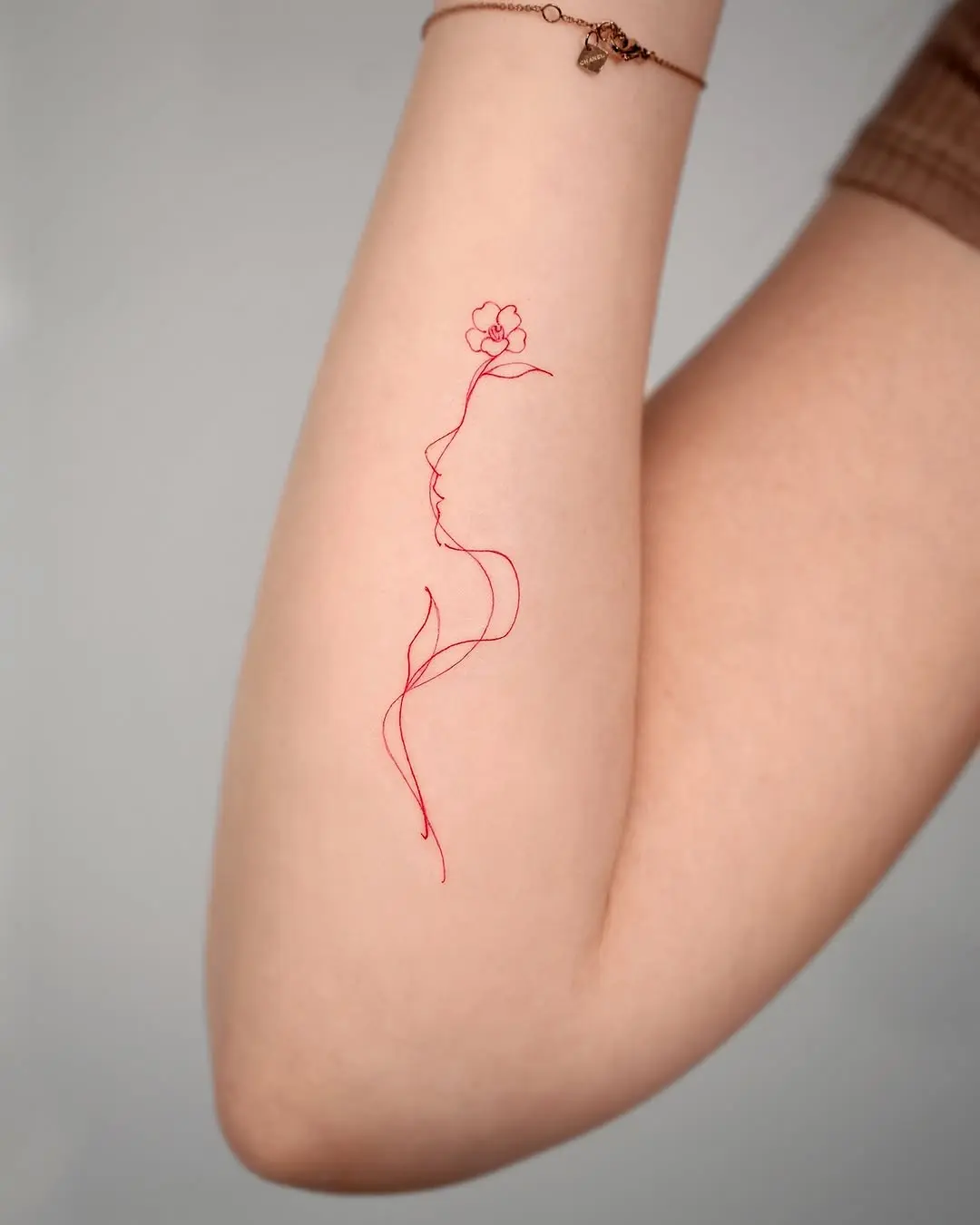 Elegant camellia tattoo on a graceful silhouette