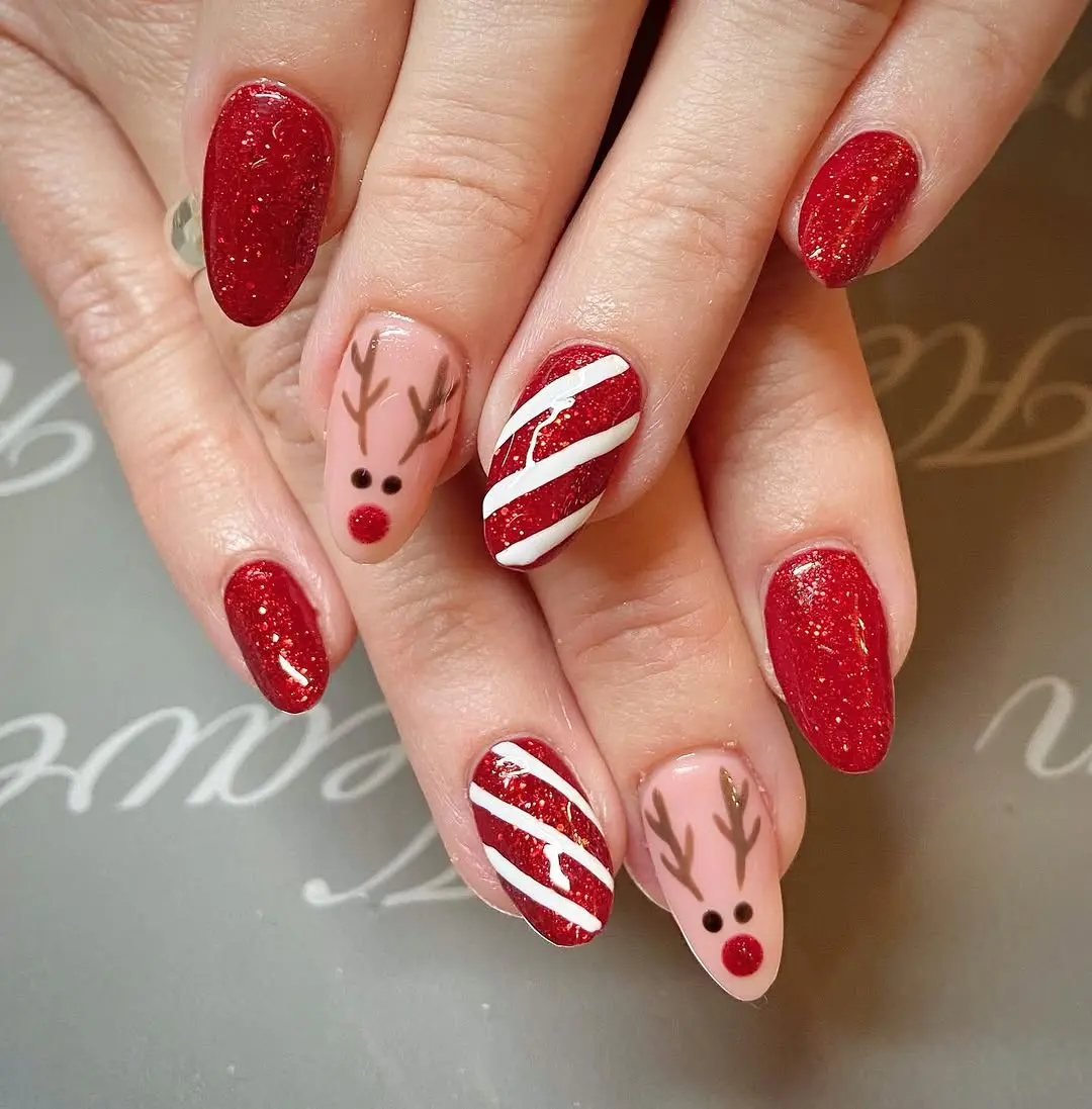 Charming candy cane nails with festive reindeer accents